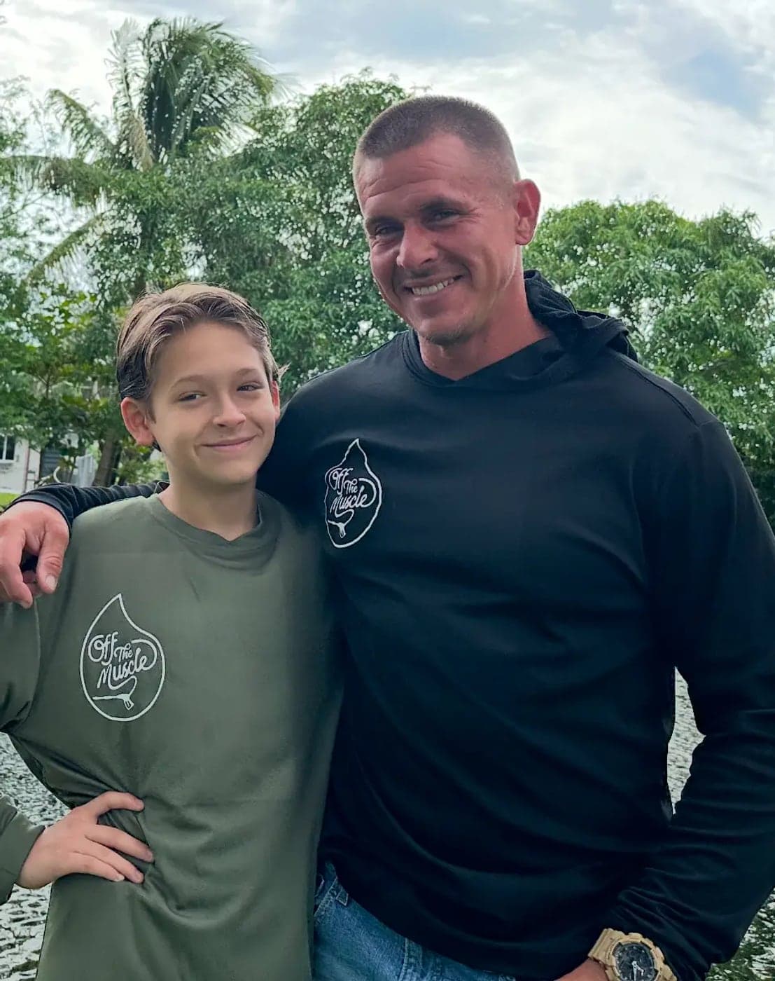Jason, owner of Off The Muscle, with his son in matching company shirts
