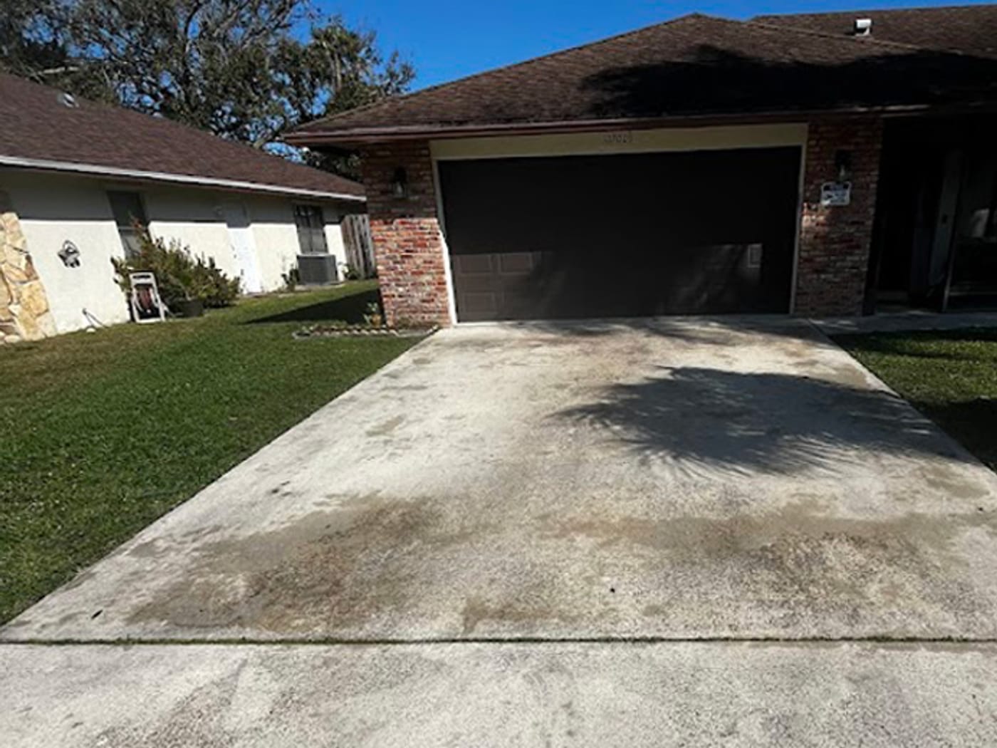 Stained, weathered driveway before pressure washing