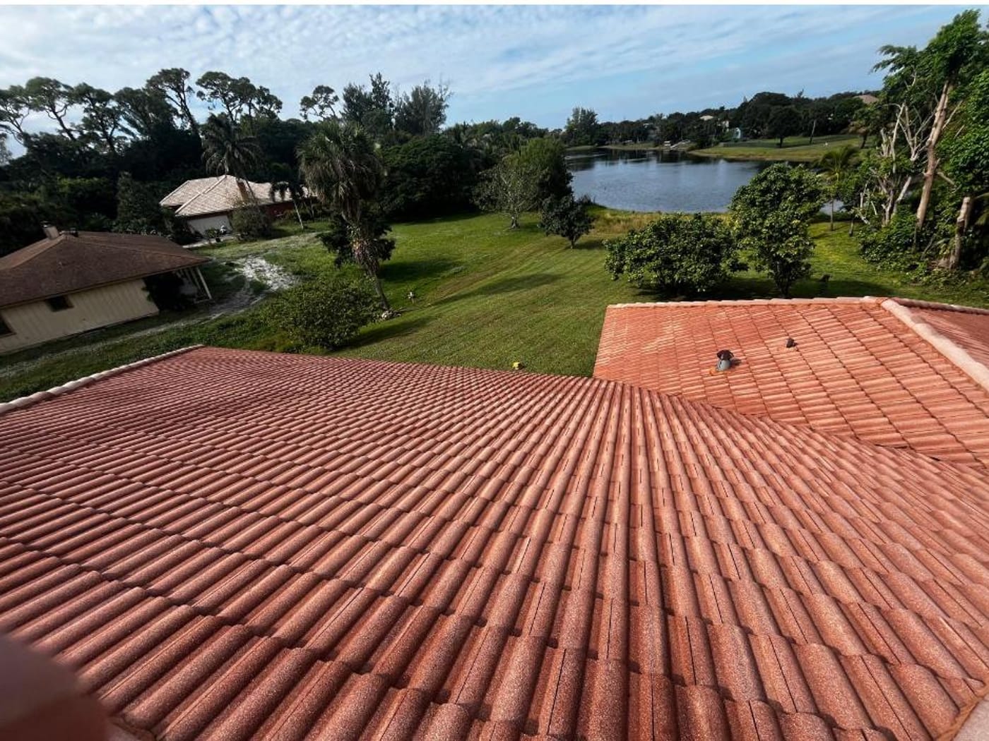 The same tile roof soft washed back to clean terracotta